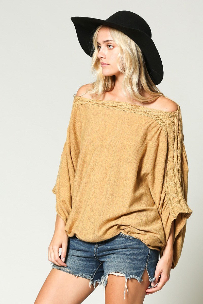 Over-sized, shapeless fit knit sweater featuring an off shoulder braided detail.